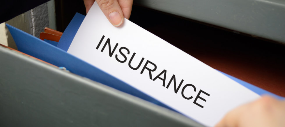 Hand seeking an insurance policy in a filing cabinet