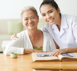 caregiver and elder woman smiling