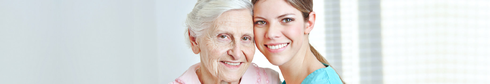 caregiver and elder woman smiling
