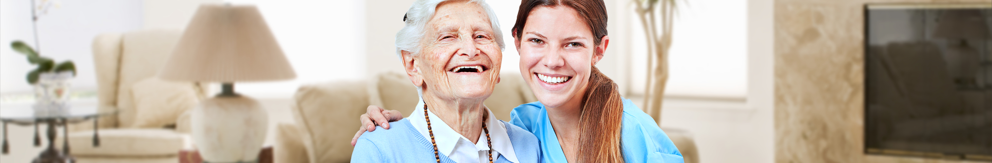 caregiver and elder woman smiling