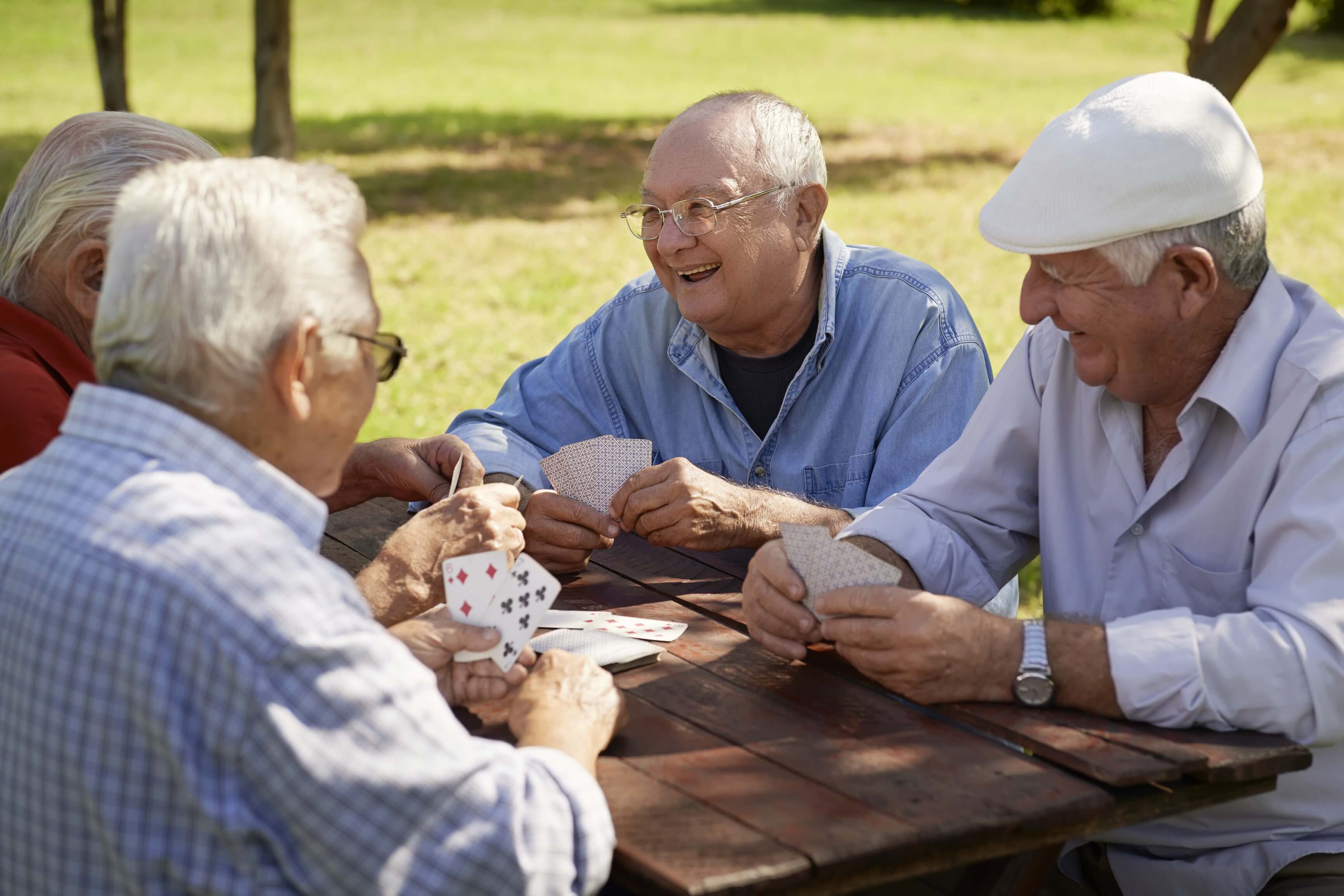 group of seniors playing cards outdoor