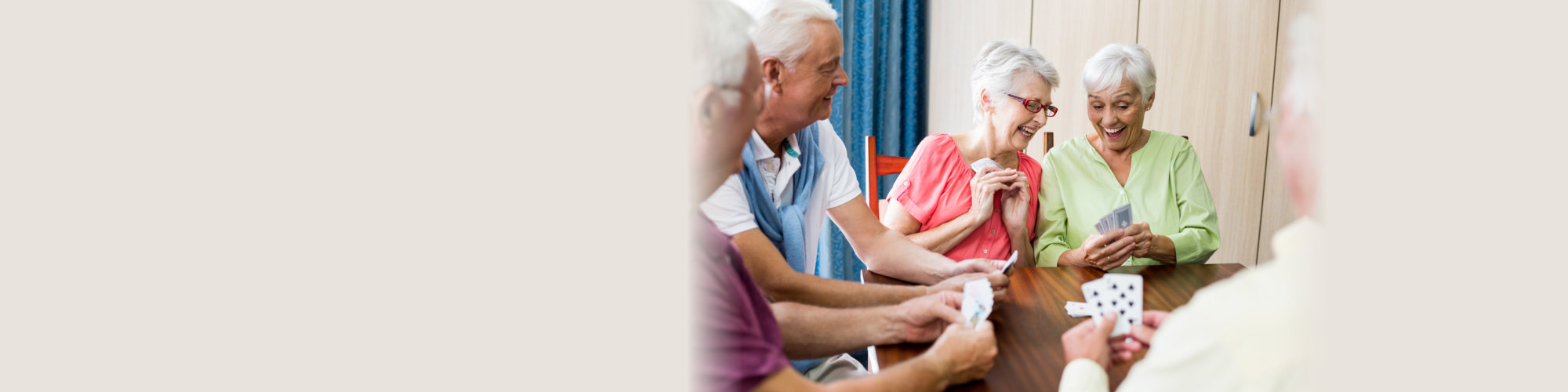 Seniors playing cards in a retirement home